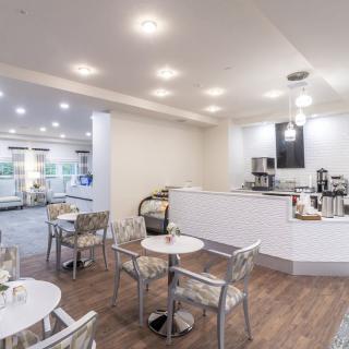 Modern cafe interior with tables and chairs arranged neatly.