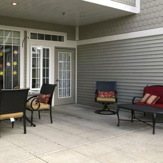A cozy patio area with outdoor seating and colorful cushions.