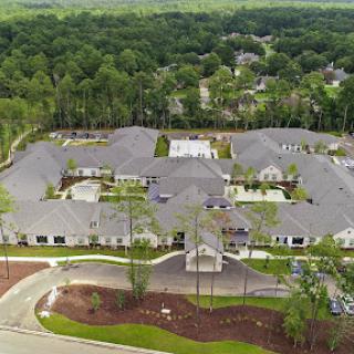 A serene aerial view of a modern residential housing complex surrounded by lush greenery.
