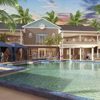 A luxurious resort with a large swimming pool and palm trees, perfect for a tropical getaway.