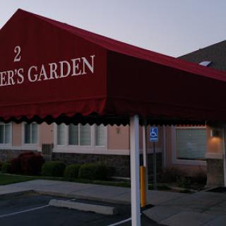 The entrance to a restaurant named 'Diner's Garden' with an awning.