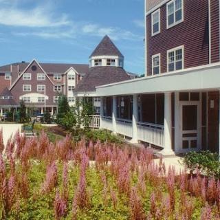 A beautifully designed resort area featuring blossoming flowers and elegant architecture.