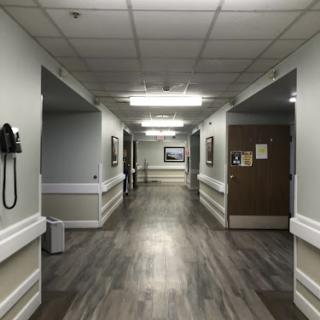 A quiet hallway in a healthcare facility, featuring clean lines and natural lighting.