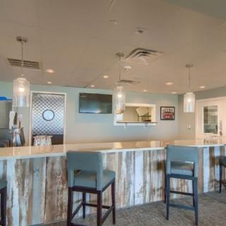 A modern bar interior with a stylish counter and comfortable seating.
