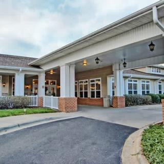 A well-maintained building with a covered entrance and landscaped surroundings.