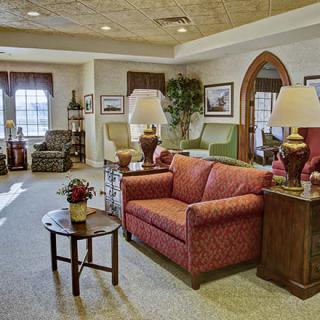 A cozy living room with sofas, lamps, and various decor elements.