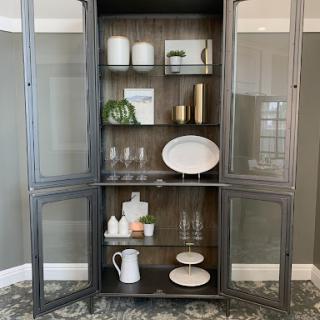 A stylish cabinet showcasing elegant dishware and home decor.