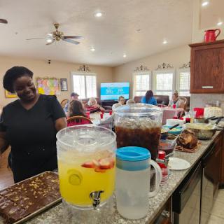 A lively gathering in the kitchen with refreshing drinks and delicious snacks.