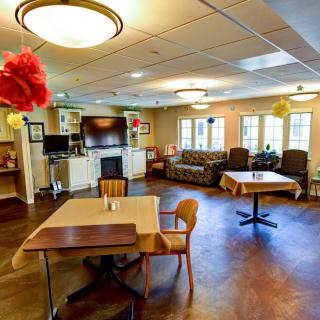 A cozy and well-decorated living room with various seating options and a television.