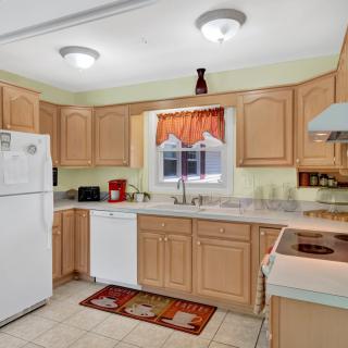 A cozy kitchen with wooden cabinets and modern appliances.