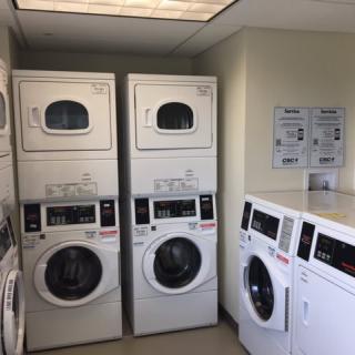A laundry room with stacked washers and dryers.
