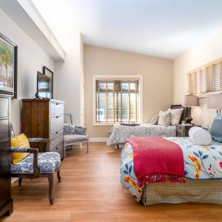 A cozy, well-decorated bedroom with vibrant bed linens and stylish furniture.