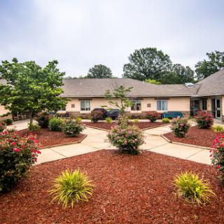 A well-maintained residential courtyard featuring beautiful landscaping and a vibrant garden.
