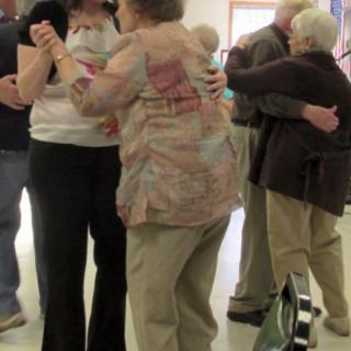 Seniors enjoying a dance at a social event.