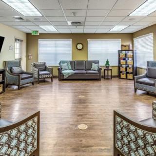 Spacious and well-lit waiting room with comfortable seating.