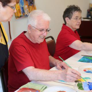 Seniors enjoying a painting session in an art class.