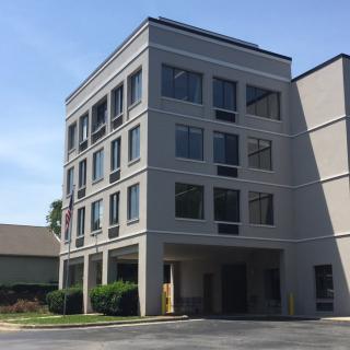 A modern office building with multiple floors and large windows.