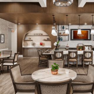 A modern kitchen and dining area featuring stylish furniture and elegant lighting.