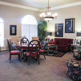 A traditional living and dining area with elegant furniture and decorative artwork.