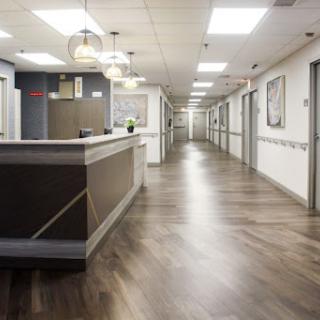 A modern healthcare facility hallway featuring a welcoming reception area.