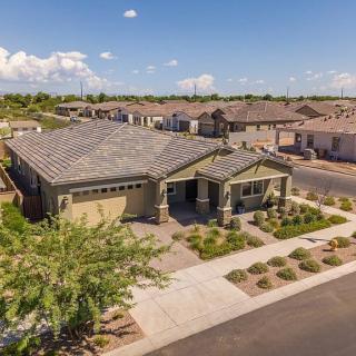 Aerial view of a modern suburban house with well-maintained landscaping.