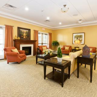 A well-decorated living room with comfortable seating and a fireplace.