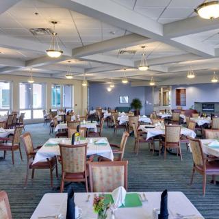 A spacious and elegantly decorated dining area with tables set for guests.