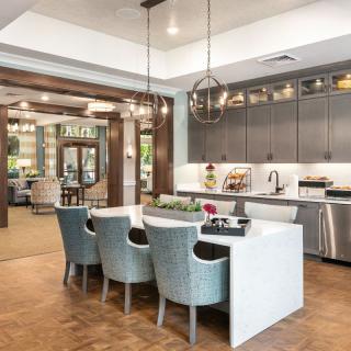 A modern kitchen and dining area with sleek design and stylish lighting.