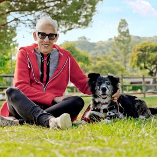 A person enjoying a sunny day in the park with their dog.