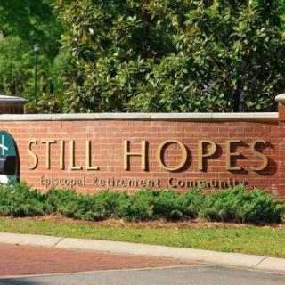 A brick sign for Still Hopes Episcopal Retirement Community.