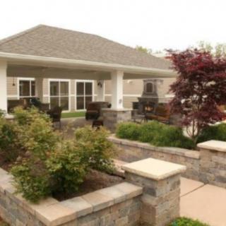 A residential house with a landscaped garden and patio area.