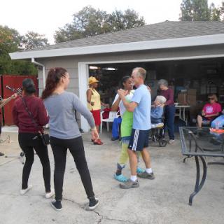 A lively outdoor gathering where friends enjoy dancing and socializing.