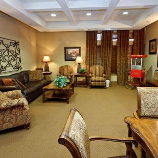 A cozy living room with comfortable seating, tasteful decor, and a popcorn machine.