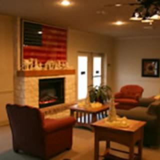 Cozy living room with a fireplace and American flag decor.