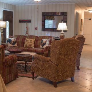 A cozy living room with patterned furniture and warm lighting.