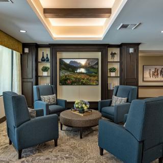 A comfortable lounge area with armchairs and a coffee table, elegantly decorated with modern interior design.