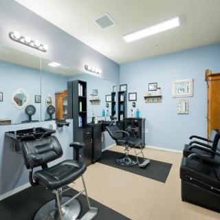 A well-organized hair salon interior with styling stations and mirrors.