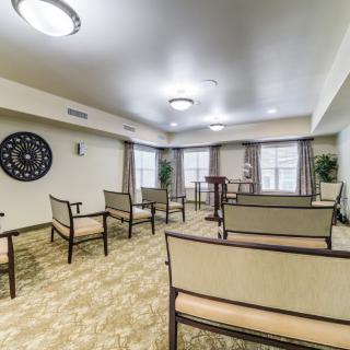 An interior view of an empty meeting room with chairs arranged in rows.