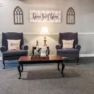A cozy living room setup featuring stylish armchairs, a classic coffee table, and inviting decorative elements.
