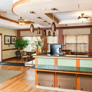 A modern hotel lobby featuring a reception desk with stylish lighting and comfortable seating.