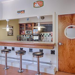 A vintage-style diner interior featuring a counter with stools.