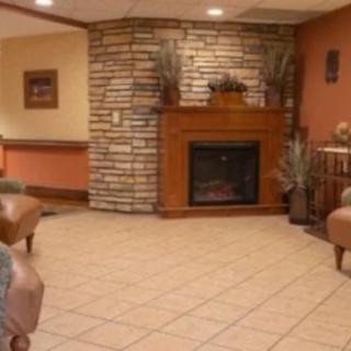 A cozy living room with a fireplace and comfortable seating.