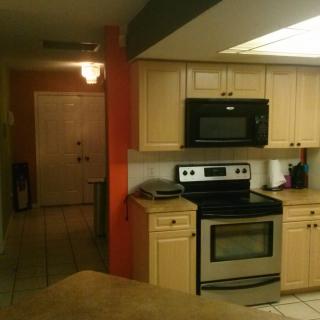 Modern kitchen with stove and microwave.