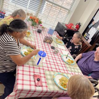 A group of people enjoying a meal together at a dining table.
