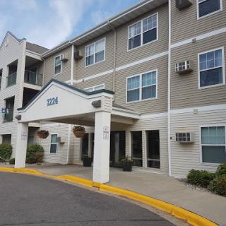 A view of a modern apartment building showcasing its entrance and surrounding area.