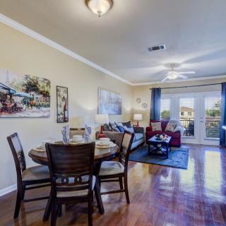 A cozy living room with a connected dining area, featuring hardwood floors and elegant decor.