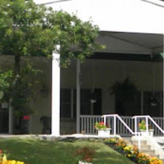 A charming house with a welcoming porch and beautiful garden.