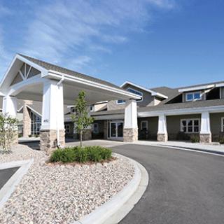 A modern residential building featuring a welcoming entrance and well-maintained landscaping.