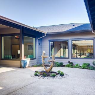 A serene courtyard featuring a fountain and large windows, creating a peaceful outdoor atmosphere.