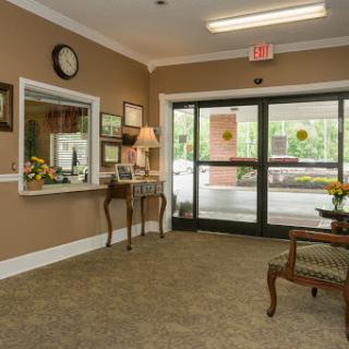 A welcoming lobby space featuring a reception desk, elegant furniture, and decorative elements.